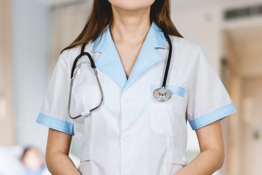 woman in white button up shirt and blue stethoscope